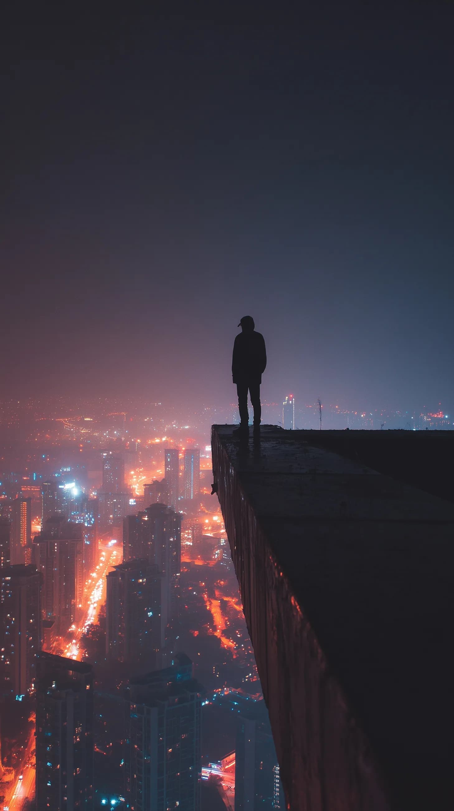 Man on Brutalist Rooftop at Night